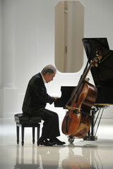 A man sitting at a piano, focused on playing a musical instrument with passion and skill