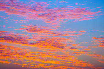 A panoramic view of colourful beatiful evening sky with pink, purple, peach and orange clouds,...