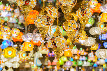 A view from below of a variety of many colorful vintage Arabic and Persian lamps and chandeliers,...