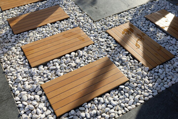 path in the garden with a combination of white pebbles and ceramic decoration.