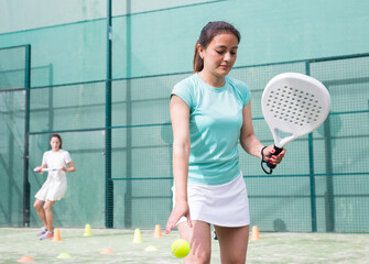 Portrait of smiling woman during padel workout training performing basic strokes