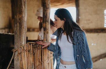 Travel enthusiast woman gazes with curiosity at a rustic farmhouse setting, experiencing local traditions on her vacation.