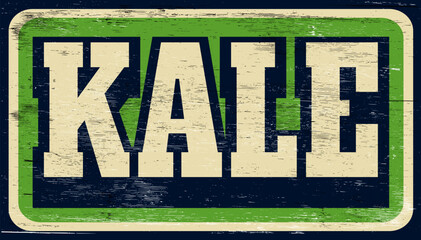 Aged and worn kale sign on wood