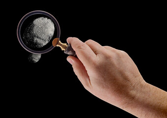 Male Hand Holding Magnifying Glass Viewing A Fingerprint on a Black Background. - 788819511