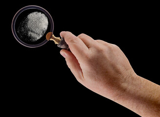 Male Hand Holding Magnifying Glass Viewing A Fingerprint on a Black Background. - 788819544