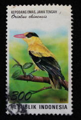 Old philatelic postage stamp with illustration of a golden oriole bird