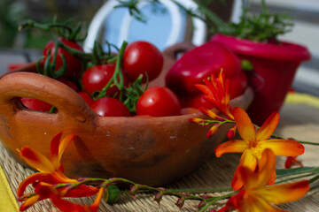 tomato and flowers on old pottery