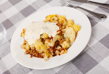 Gordijnen Delicious fried cauliflower with sour cream served on plate © JackF