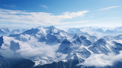 Obraz premium This is a beautiful landscape photograph of snow-capped mountains. The image is taken from a high angle and looks down on the mountains.