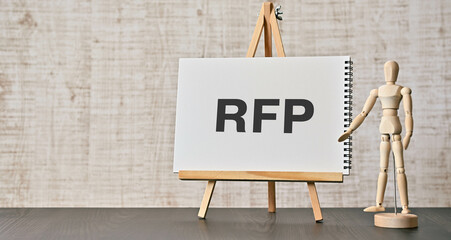 There is notebook with the word RFP. It is an abbreviation for Request For Proposal as eye-catching image.
