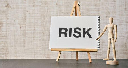 There is notebook with the word RISK. It is as an eye-catching image.
