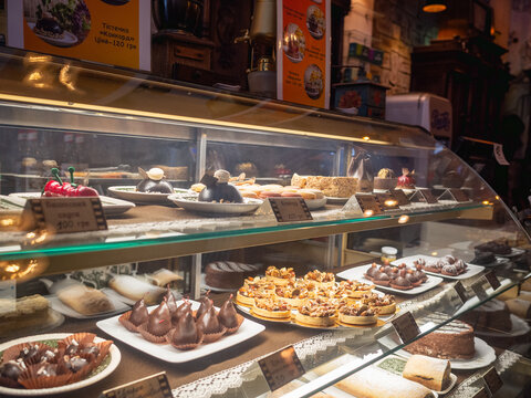 a lot of sweets in the show case of the cafe in lviv old city