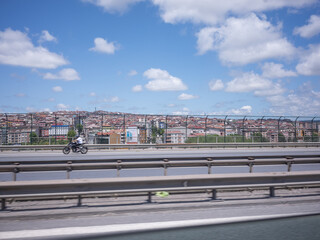 cityscape and a motorcycle passing on the highway in istanbul