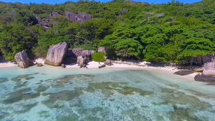 Fototapeta na wymiar Anse Source D'Argent Beach in La Digue, Seychelles. Aerial view of tropical coastline on a sunny day
