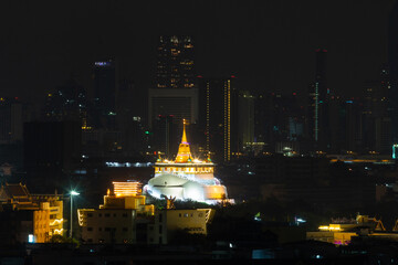 Golden Mountain at Wat Saket Ratcha Worawihan is a Buddhist temple on a mountain at night. It is a tourist landmark of Bangkok, Thailand.