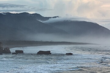 Ocean beach cliffs and mist in New Zealand - 788828796