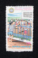 Vintage philatelic stamp with illustration of children going to school