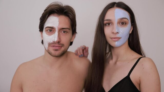 Man and woman wearing face masks covering nose, mouth, and chin