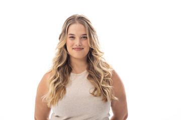 Young caucasian female plus size model standing on white background, wearing sleeveless top, smiling - 788839924