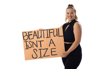 Caucasian young female plus size model holding poster, smiling brightly on white background - 788839927