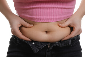 Woman touching belly fat on white background, closeup. Overweight problem - obrazy, fototapety, plakaty