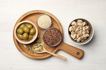 Different products high in vegetable fats on white wooden table, flat lay