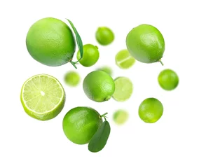 Outdoor kussens Fresh ripe limes in air on white background © New Africa