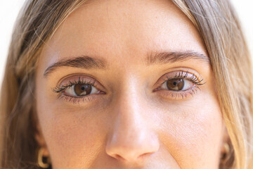 Caucasian woman with light brown eyes is looking forward in studio
