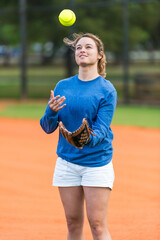 Young woman catching softball