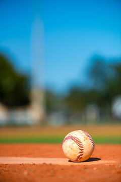 Close up baseball on Pitcher's Mound on sunny summer day 