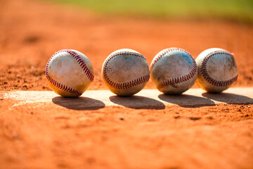Four worn baseballs on Pitcher's Mound