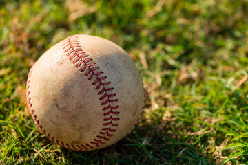 Close up of well worn baseball on grass