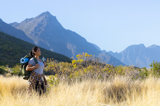Biracial female hiker standing in mountain landscape, copy space