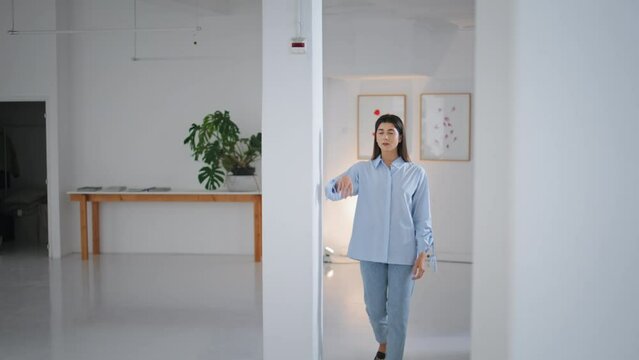 Successful businesswoman posing office. Confident brunette woman lean white wall
