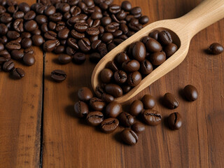 Fototapeta premium Top view of wooden spoon filled with coffee beans