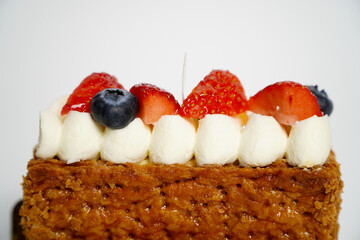 Fruit cake decorated with strawberries and blueberries on a white background,Mille Feuille, crispy pie dough, alternating layers with Special Pastry Cream, real vanilla cream, fragrant and soft.