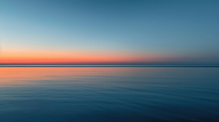 Obraz premium Gentle dawn over tranquil sea with minimalist clouds for serene panoramic background