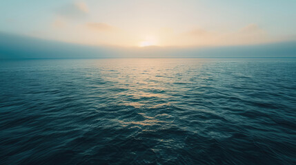 Obraz premium Gentle dawn over tranquil sea with minimalist clouds for serene panoramic background