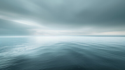 Peaceful ocean expanse under overcast skies in soothing shades