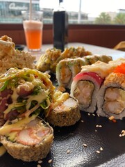 Tempura rolls of Kamikama with seaweed on a plate, set against the background of a Peruvian Nikkei restaurant