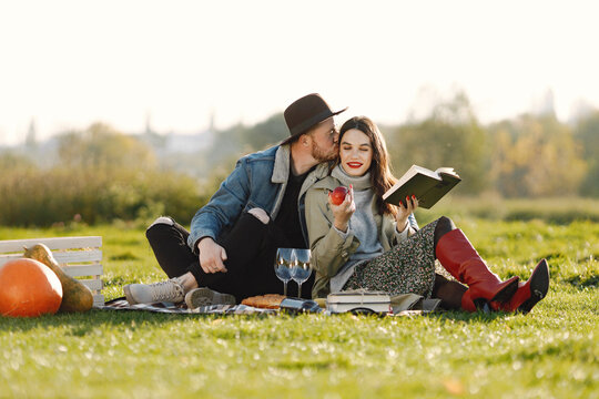 Stylish couple have a picnic with a glasses of wine on a nature
