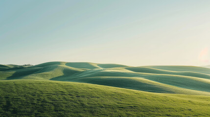 Obraz premium Panoramic view of gentle rolling green hills under a clear blue sky in a minimalist landscape