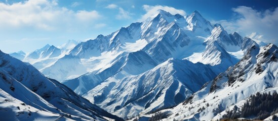 Panoramic view of snow-capped mountains and blue sky - obrazy, fototapety, plakaty