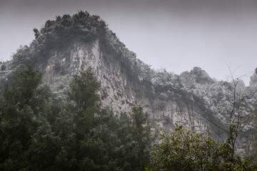 Karst mountains covered in snow in Wulong China Karst, Chongqing - obrazy, fototapety, plakaty
