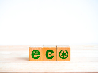 Eco friendly and earth care concept. Alphabet idea design "ECO" on wooden cube blocks, ornate with icons, planting tree, checkmark and recycle symbol, isolated on white background with copy space.