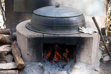 View of the iron pot on the burning firewood