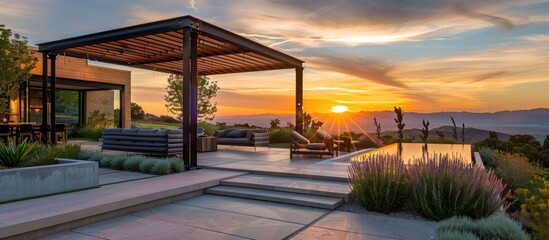 Interior design: Attractive contemporary outdoor seating area with a pergola during sunset.