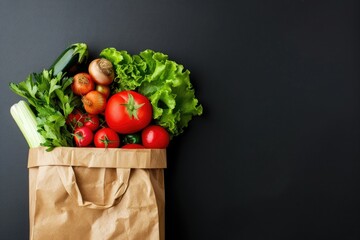 Paper bag full of fresh organic vegetables on black background. Healthy food shopping concept