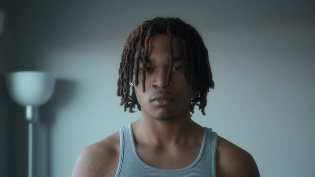 Portrait of a young male with dreadlocks. Slow motion. 