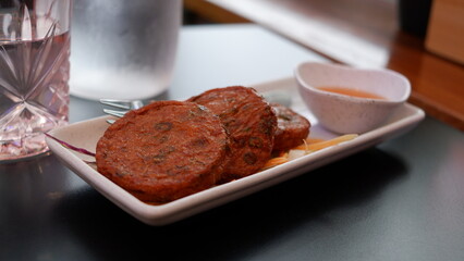 Thai fish patties or Tod Mun Pla is a Thai dishes made from ground fish mixed with Thai spices served with sweet and sour dipping sauce.